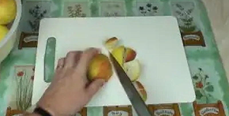 Step 2: Coarsely chopping fresh whole apples on a cutting board leaving skins and seeds intact