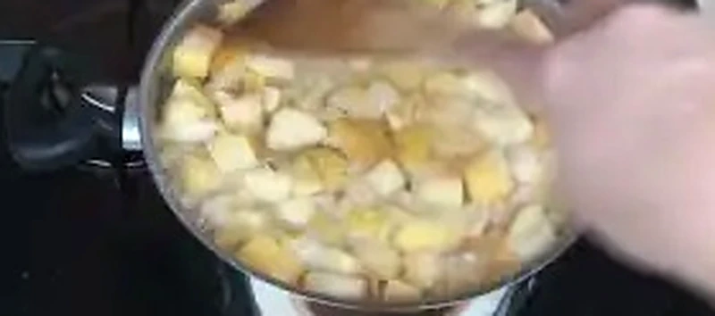 Step 3: Simmering chopped apples in cold water in a large stainless steel pot until soft