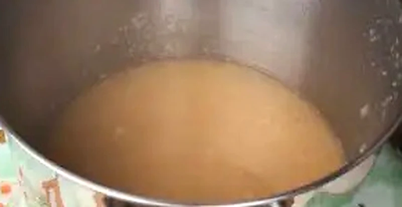 Step 5: Crystal clear golden apple juice in the preserving pan ready for sugar